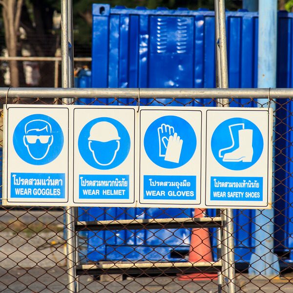 Une clôture en maillon de chaîne, soulignant l'importance de la signalisation dans les environnements industriels.